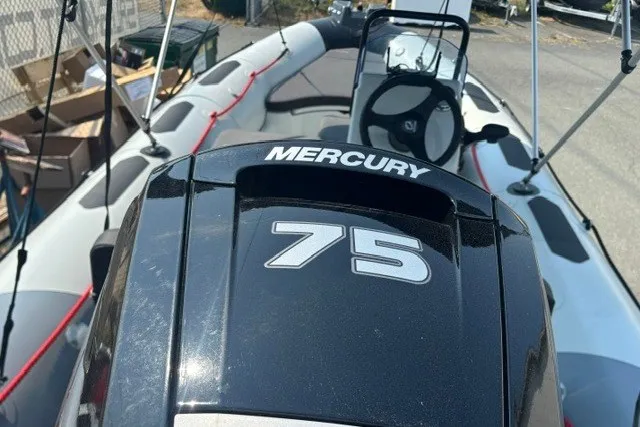 The Image of 2024 Zodiac Open 4.8 boat with Mercury 75 engine, docked outdoors. - 1