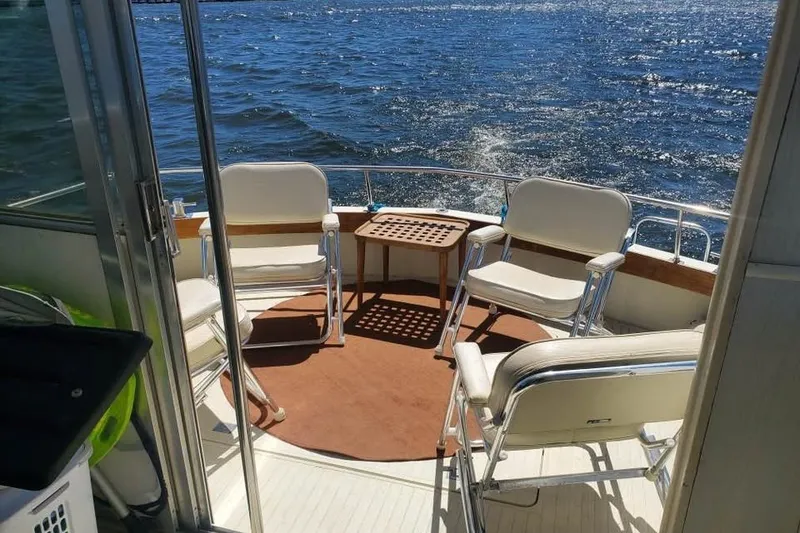 Slide: The Image of 1971 Chris-Craft 38 Commander boat deck with chairs overlooking the water. - 10