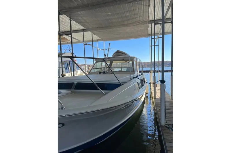Slide: The Image of 1971 Chris-Craft 38 Commander docked under a covered marina with clear blue skies. - 5