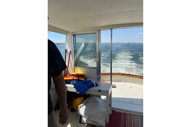 Slide: The Image of 1971 Chris-Craft 38 Commander interior with lake view, colorful life jackets, and open water. - 12