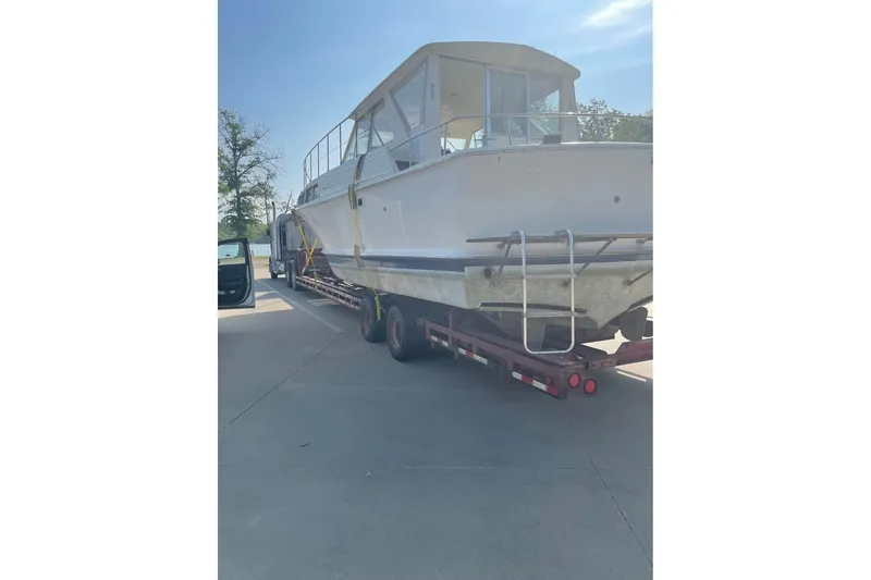 Slide: The Image of 1971 Chris-Craft 38 Commander boat on trailer under clear sky. - 1