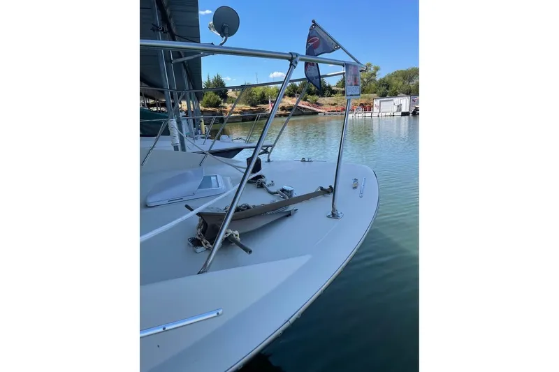 Slide: The Image of 1971 Chris-Craft 38 Commander boat docked, featuring a "For Sale" sign and calm waters. - 4