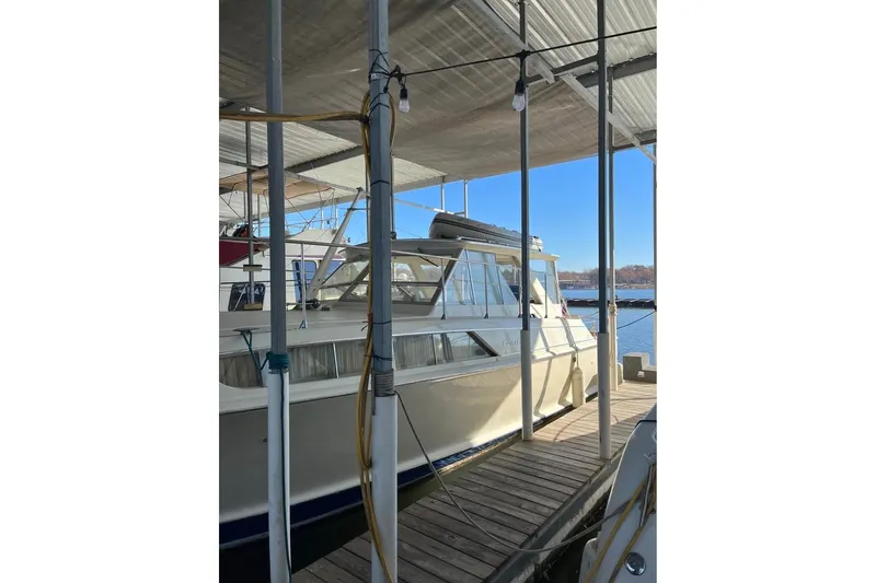 Slide: The Image of 1971 Chris-Craft 38 Commander docked under a covered marina. - 2
