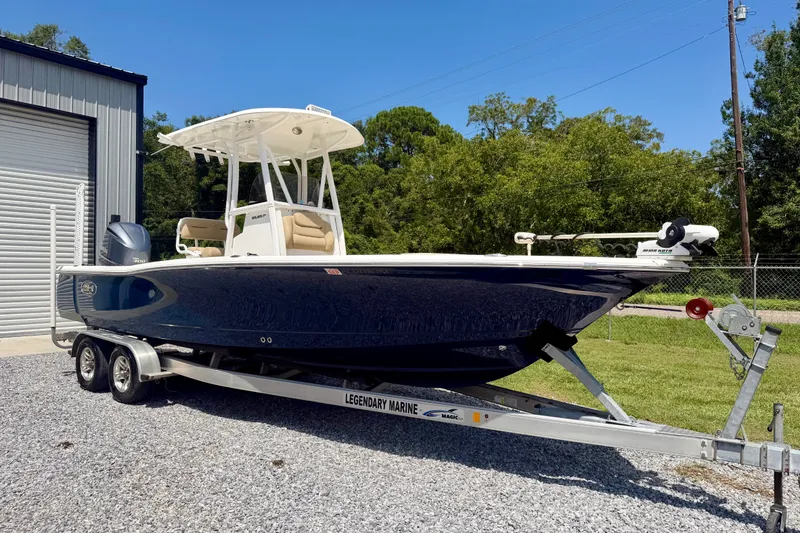 The Image of 2017 Sea Hunt BX25BR boat on trailer, parked outside a garage. - 1