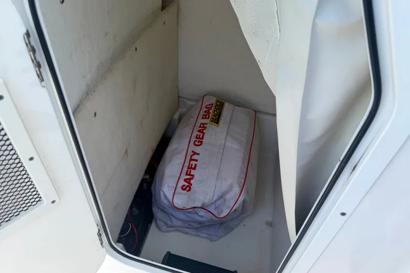 Slide: The Image of Safety gear bag inside 2017 Sea Hunt BX25BR boat compartment. - 8