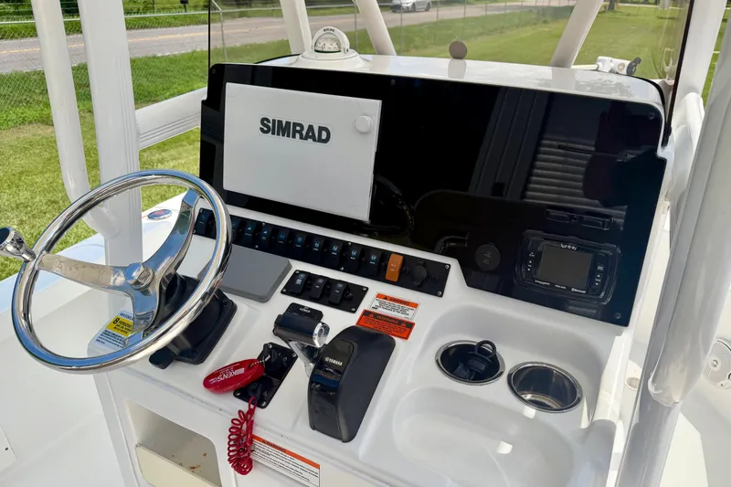 Slide: The Image of 2017 Sea Hunt BX25BR boat dashboard with Simrad display and steering wheel. - 10