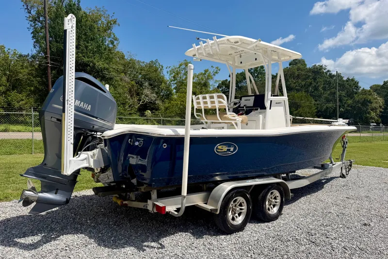 Slide: The Image of 2017 Sea Hunt BX25BR boat on trailer with Yamaha engine, parked outdoors. - 3