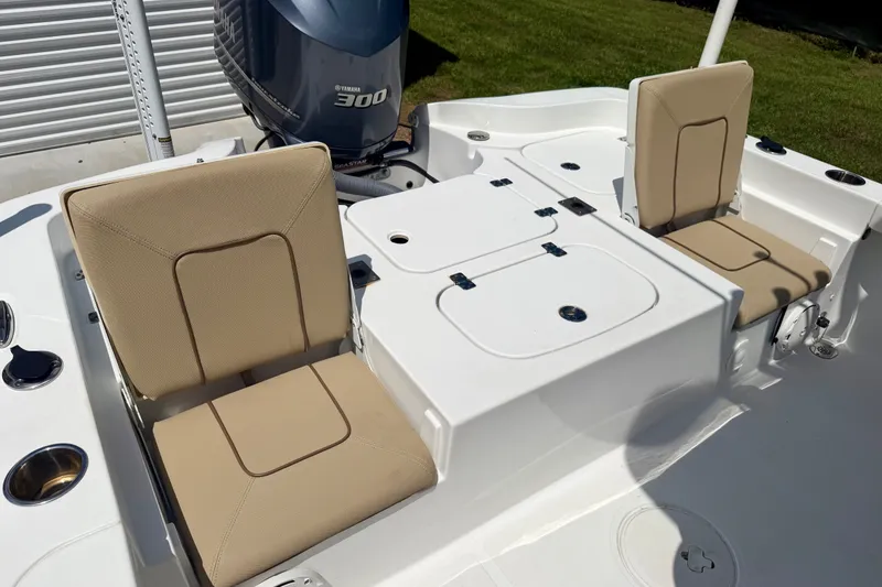 Slide: The Image of 2017 Sea Hunt BX25BR boat interior with beige seating and Yamaha 300 engine. - 15