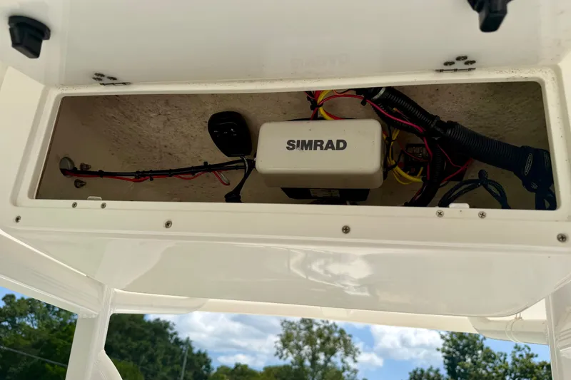 Slide: The Image of 2017 Sea Hunt BX25BR boat electronics compartment with Simrad equipment and wiring. - 11