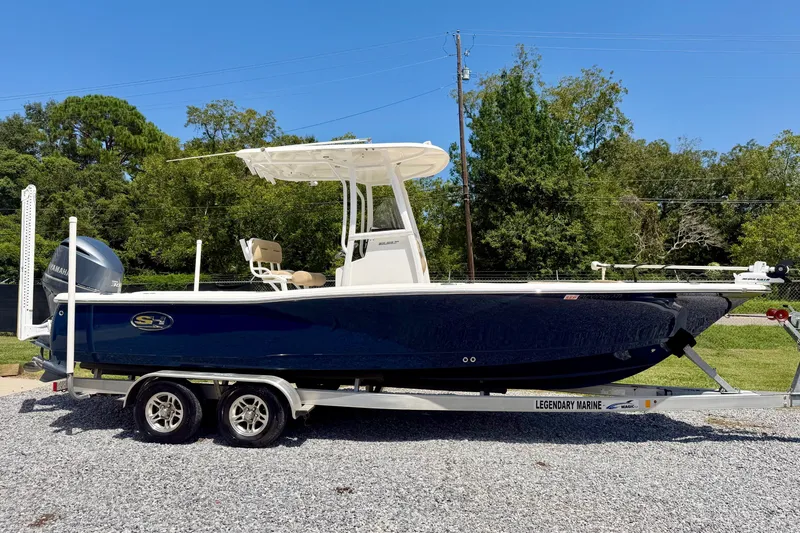 Slide: The Image of 2017 Sea Hunt BX25BR boat on trailer, parked outdoors on gravel. - 2