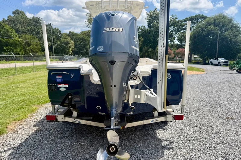 Slide: The Image of 2017 Sea Hunt BX25BR boat with 300 horsepower engine on a gravel driveway. - 4