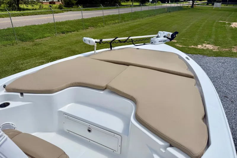 Slide: The Image of 2017 Sea Hunt BX25BR boat with beige cushioned bow seating and trolling motor. - 5