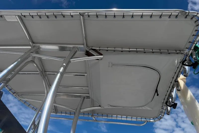 Slide: The Image of Custom West End Boat Works 25, 2026 model, featuring sleek metal framework and canopy against blue sky. - 16