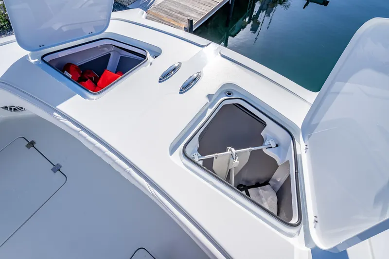Slide: The Image of Open storage compartments on a 2026 Freeman 35 boat deck, featuring life jackets and equipment. - 15