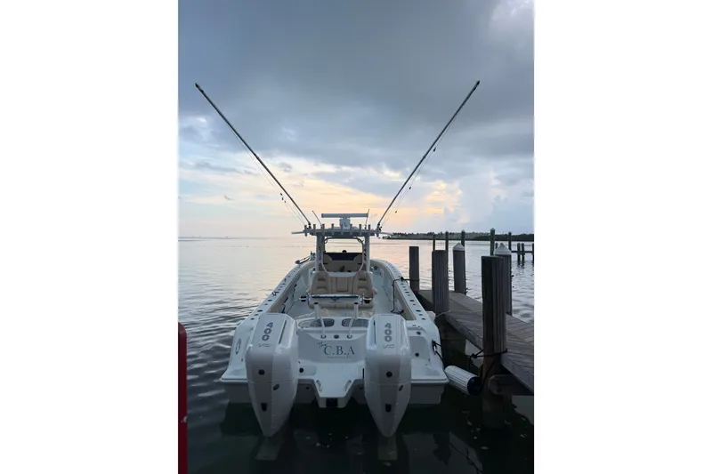 The Image of Freeman 35 boat docked at sunset, 2025 model, with dual engines and fishing rods. - 0