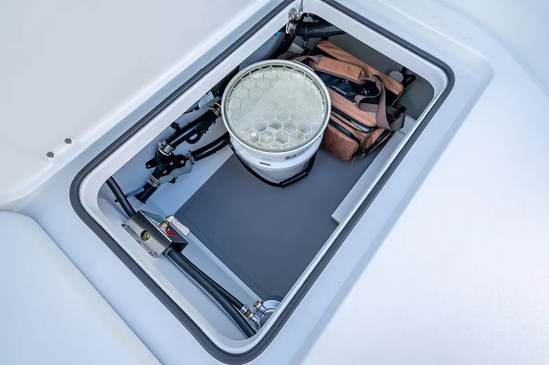 Slide: The Image of Storage compartment in a 2026 Freeman 35 boat, featuring equipment and a bag. - 16