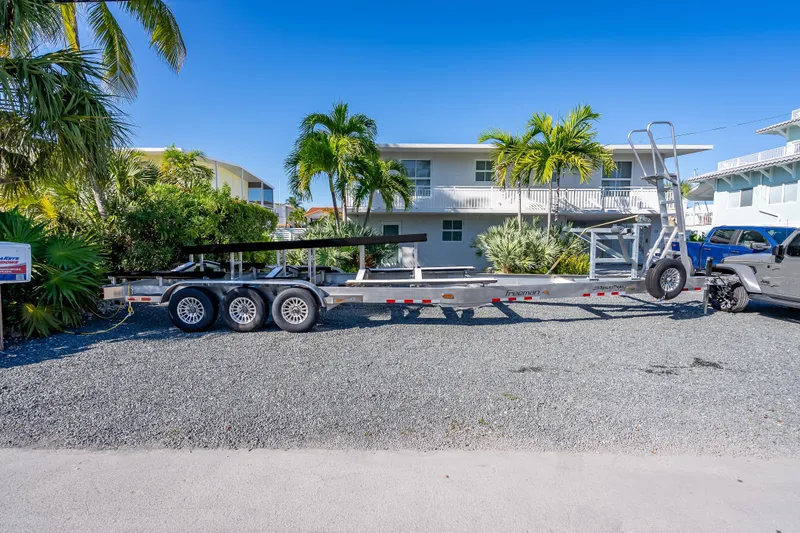 Slide: The Image of Trailer for Freeman 35, 2026 model, parked on gravel with tropical backdrop. - 18