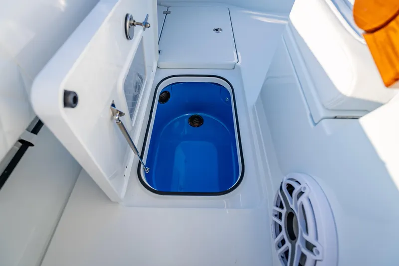 Slide: The Image of Freeman 35 boat interior, featuring a blue livewell and storage compartments, 2026 model. - 13