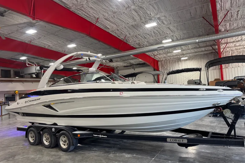 The Image of 2020 Crownline 290 SS boat on trailer in indoor showroom setting. - 1