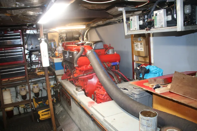 Slide: The Image of Engine room of a 1981 Marine Trader 48 Trawler with visible red engine components. - 19