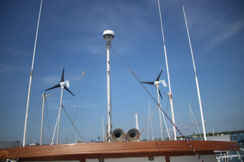 Slide: The Image of 1981 Marine Trader 48 Trawler with wind turbines and antennas against a clear blue sky. - 21
