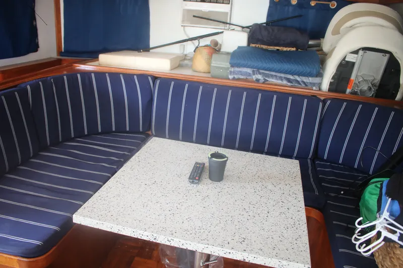 Slide: The Image of Interior of 1981 Marine Trader 48 Trawler with striped seating and speckled table. - 24