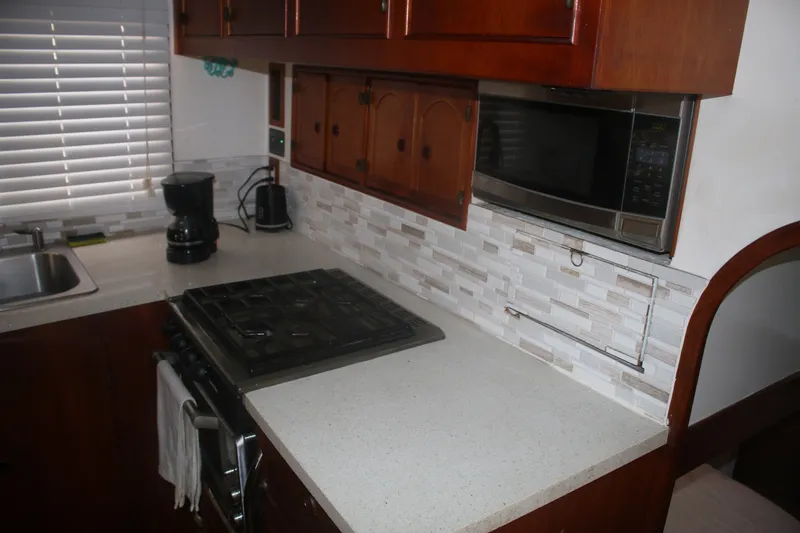 Slide: The Image of 1981 Marine Trader 48 Trawler kitchen with stove, microwave, and coffee maker. - 35