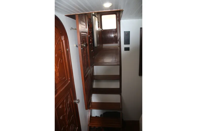 Slide: The Image of Wooden interior stairs on a 1981 Marine Trader 48 Trawler yacht. - 29