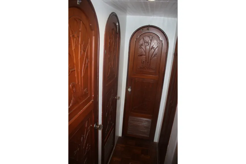 Slide: The Image of Wooden interior doors with intricate carvings on a 1981 Marine Trader 48 Trawler. - 36