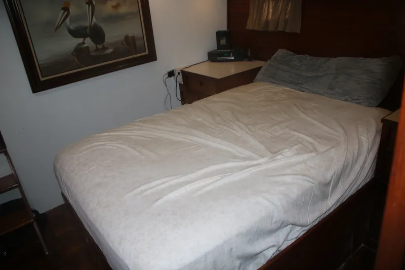 Slide: The Image of Cozy bedroom in 1981 Marine Trader 48 Trawler with pelican artwork and comfortable bedding. - 41