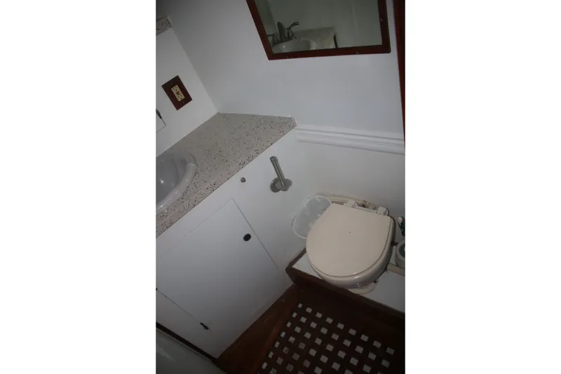 Slide: The Image of 1981 Marine Trader 48 Trawler bathroom with sink, countertop, and toilet. - 38