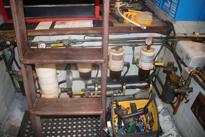 Slide: The Image of Engine room of 1981 Marine Trader 48 Trawler with tools and fuel filters. - 52