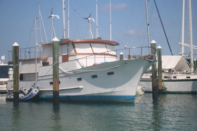 The Image of 1981 Marine Trader 48 Trawler docked at marina, surrounded by other boats. - 1