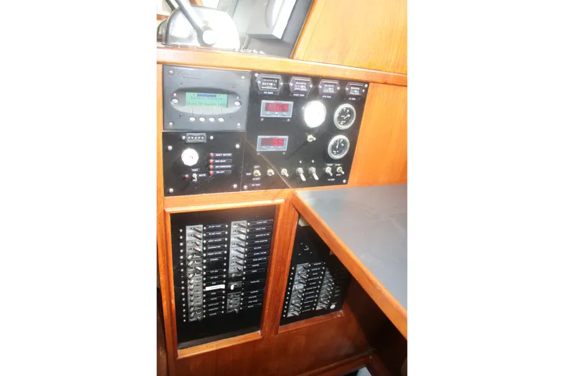 Slide: The Image of Control panel of a 1981 Marine Trader 48 Trawler with gauges and switches. - 26