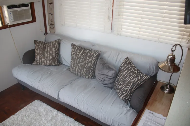 Slide: The Image of Interior of 1981 Marine Trader 48 Trawler with cozy sofa and decorative pillows. - 51