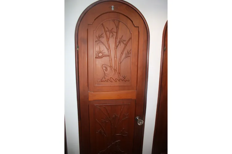 Slide: The Image of Wooden door with intricate carvings on a 1981 Marine Trader 48 Trawler. - 40