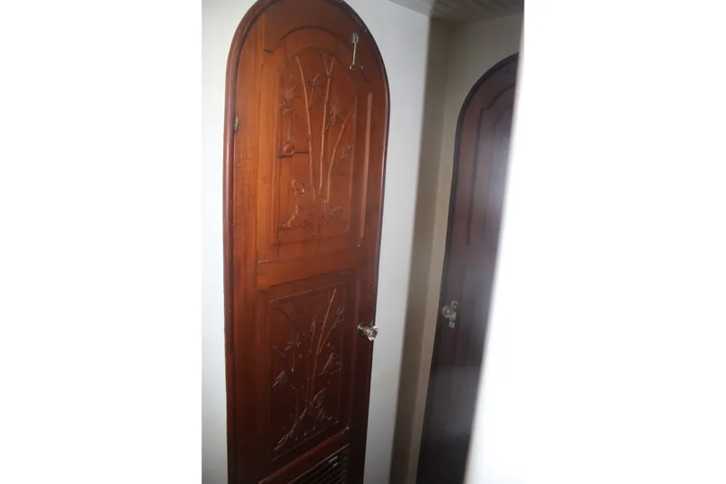 Slide: The Image of Wooden door with intricate carvings inside a 1981 Marine Trader 48 Trawler. - 39
