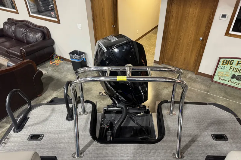 Slide: The Image of 2026 Sylvan X5 CLZ boat with Mercury engine in showroom setting. - 15