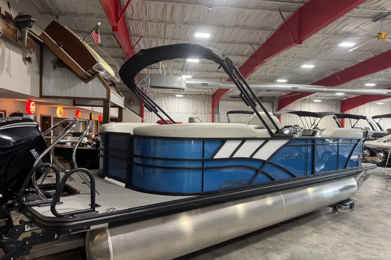 Slide: The Image of 2026 Sylvan X5 CLZ pontoon boat in showroom, featuring sleek blue design and modern amenities. - 3