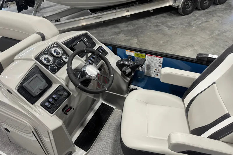 Slide: The Image of Interior view of 2026 Sylvan X5 CLZ boat dashboard with steering wheel and controls. - 11