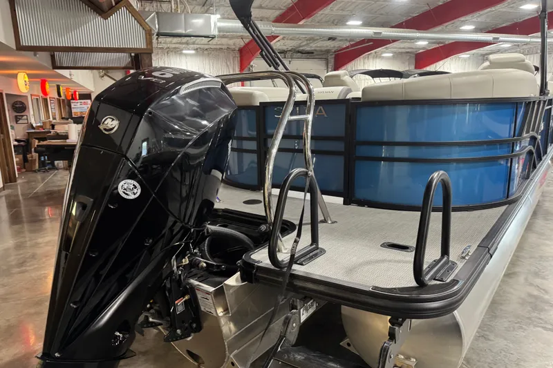 Slide: The Image of 2026 Sylvan X5 CLZ pontoon boat with powerful outboard motor in a showroom. - 5