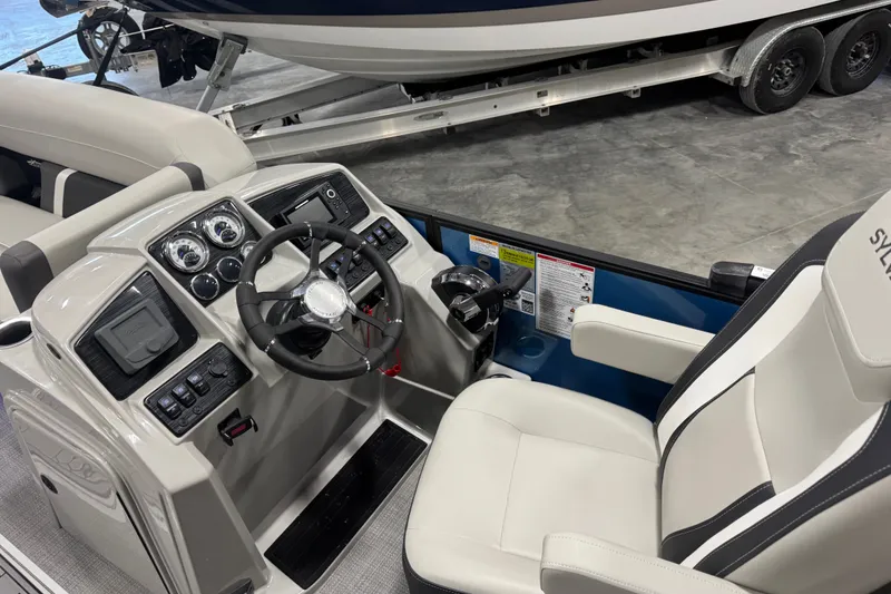 Slide: The Image of Interior of 2026 Sylvan X5 CLZ boat with modern dashboard and steering wheel. - 13