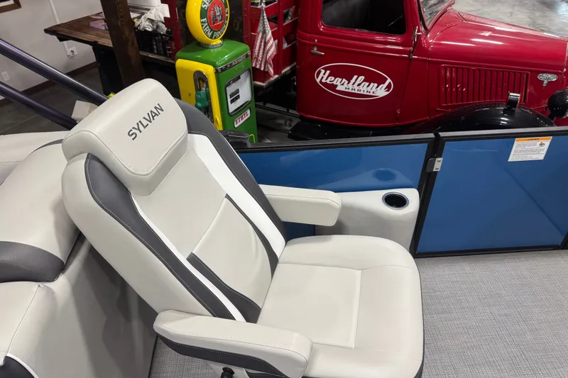 Slide: The Image of Sylvan X5 CLZ 2026 boat seat with vintage red truck and gas pump in background. - 10