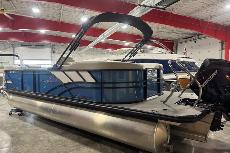 Slide: The Image of 2026 Sylvan X5 CLZ pontoon boat in showroom with Mercury outboard motor. - 7