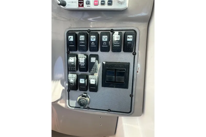 Slide: The Image of Control panel of a 2005 Wellcraft 252 Coastal boat with various switches and buttons. - 22