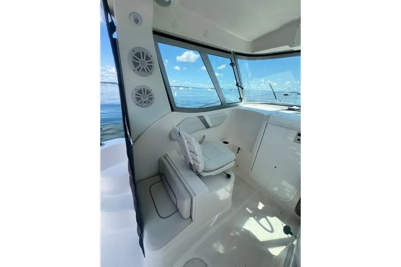 Slide: The Image of 2005 Wellcraft 252 Coastal boat interior with seating and windows overlooking the water. - 17