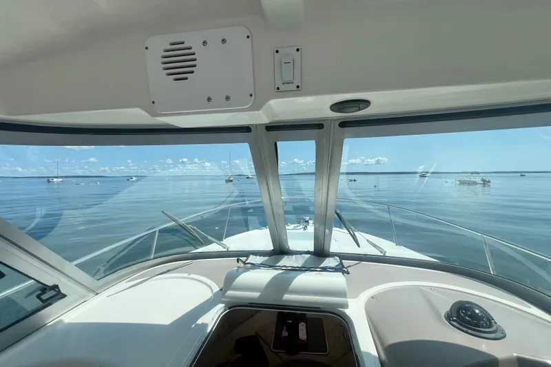 Slide: The Image of View from 2005 Wellcraft 252 Coastal boat cockpit, overlooking calm sea and distant boats. - 13