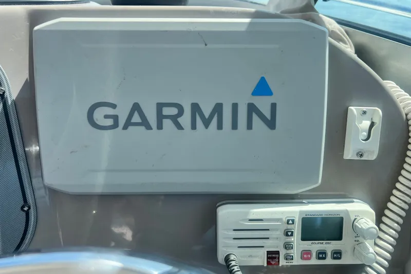 Slide: The Image of Garmin navigation system on 2005 Wellcraft 252 Coastal boat dashboard with radio equipment. - 25