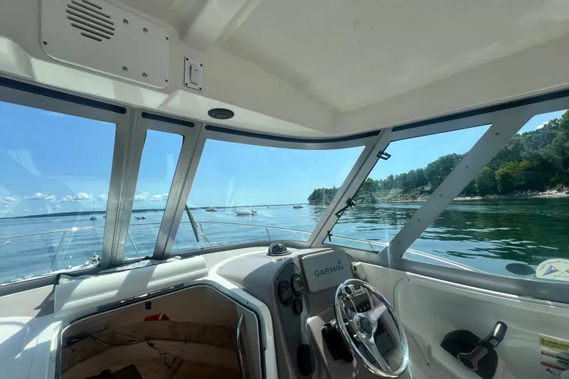 Slide: The Image of Interior view of 2005 Wellcraft 252 Coastal boat with Garmin navigation, overlooking serene waters. - 18