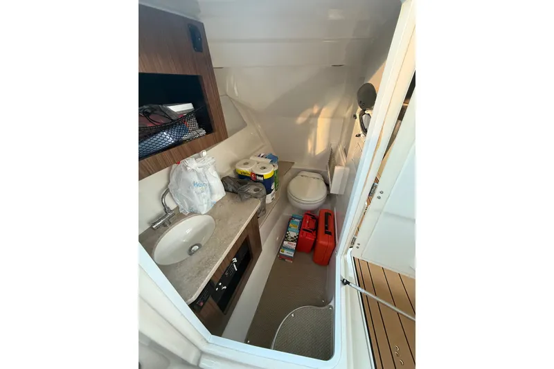Slide: The Image of Interior of 2017 Sailfish 325 DC boat bathroom with sink and toilet. - 5